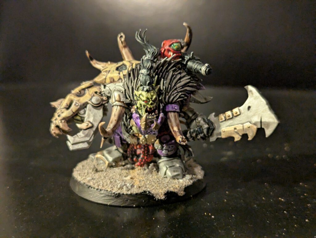 Close up of a painted Ork Beastboss from the Combat Patrol, showing skin tones and leather texture details.