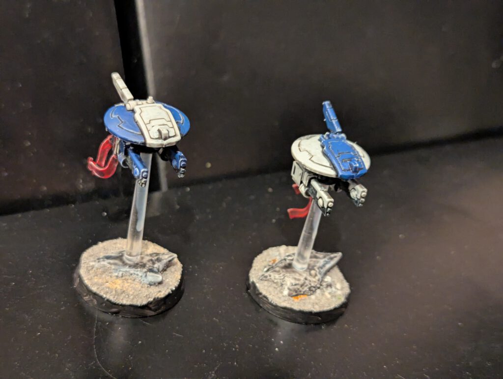 A pair of painted T'au Empire Tactical Drones from the Twin Lance set.
