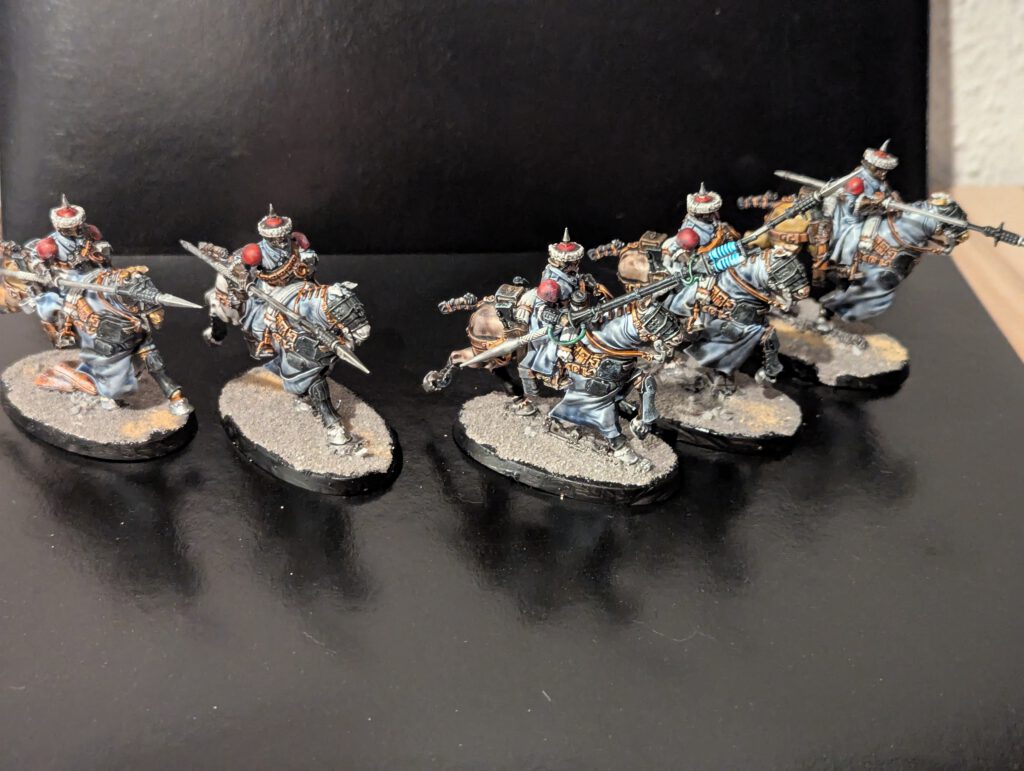 Five Astra Militarum Attilan Rough Riders mounted on horses, charging forward with hunting lances raised.