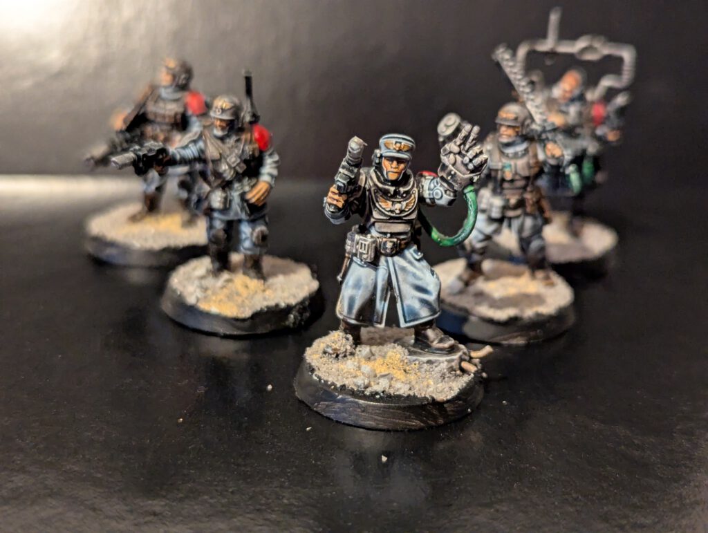 The complete five-model Cadian Command Squad, including a Commander, Medic, Veteran, Regimental Standard Bearer, and Vox-operator.