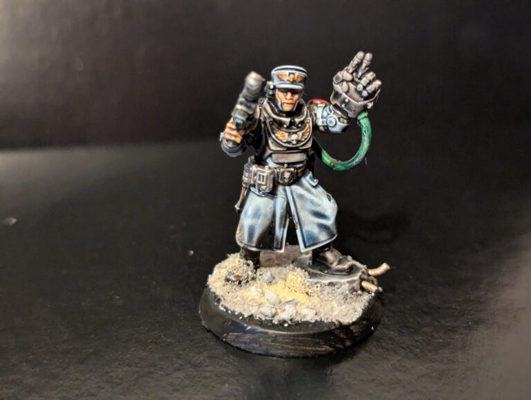 High-contrast Cadian Commander holding a power fist and pistol.
