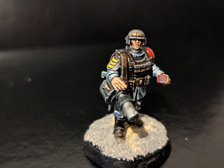 Veteran Guardsman holding a massive Grenade Launcher and a Grenade