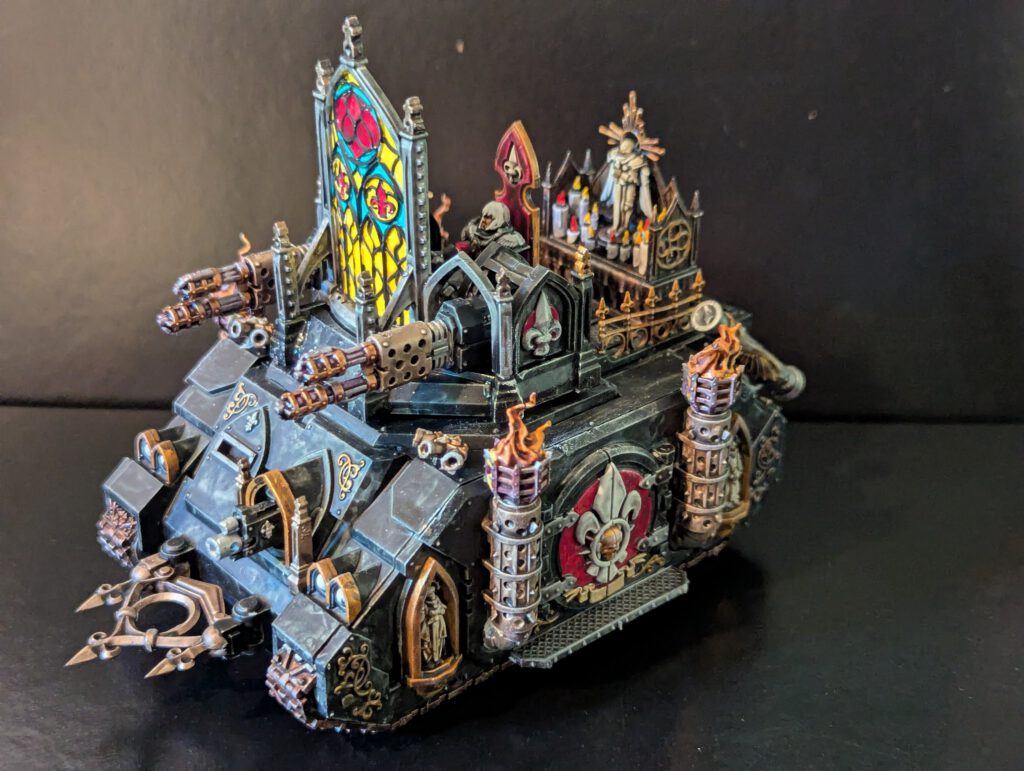 Side view of the painted Immolator highlighting the red and white Fleur-de-lis iconography on the chassis and the weathered metallic finish on the exhaust pipes.