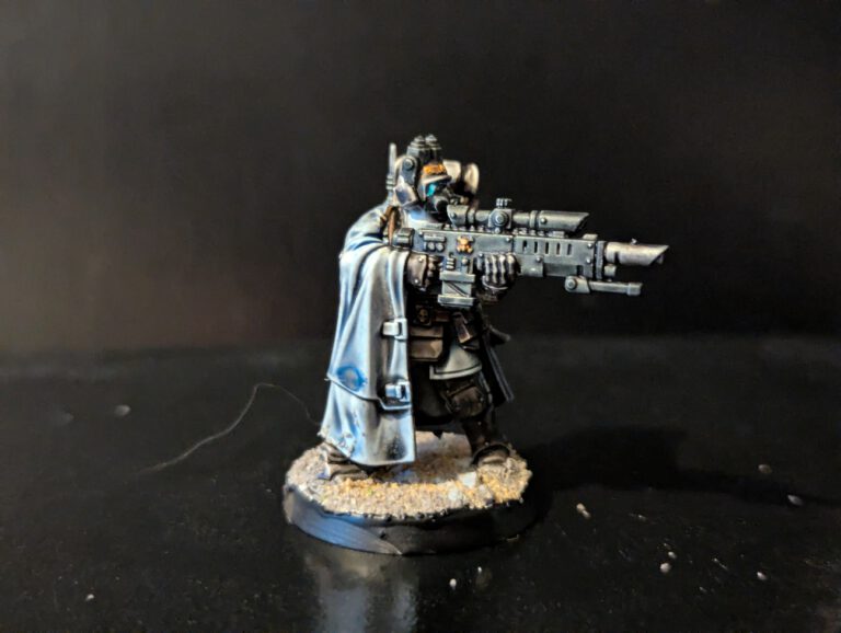 Kasrkin sniper miniature aiming a hot-shot marksman rifle, with detailed camo cloak effects.