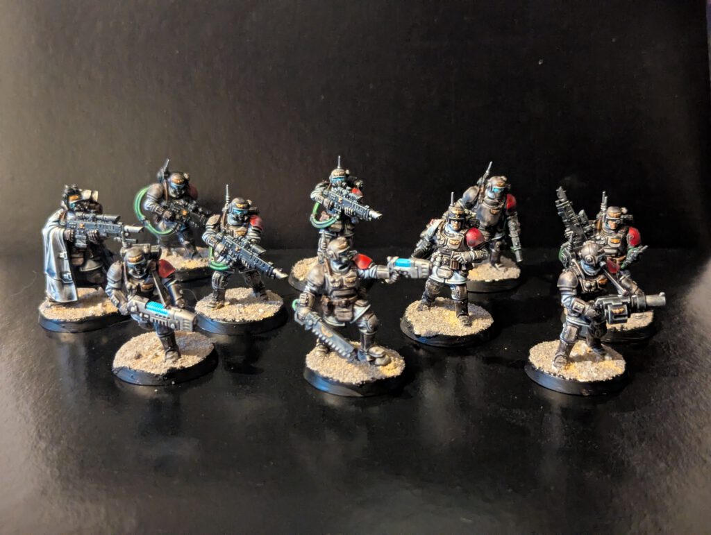 A full ten-model unit of painted Kasrkin special forces, showcasing a cohesive military camouflage scheme and special weapons.