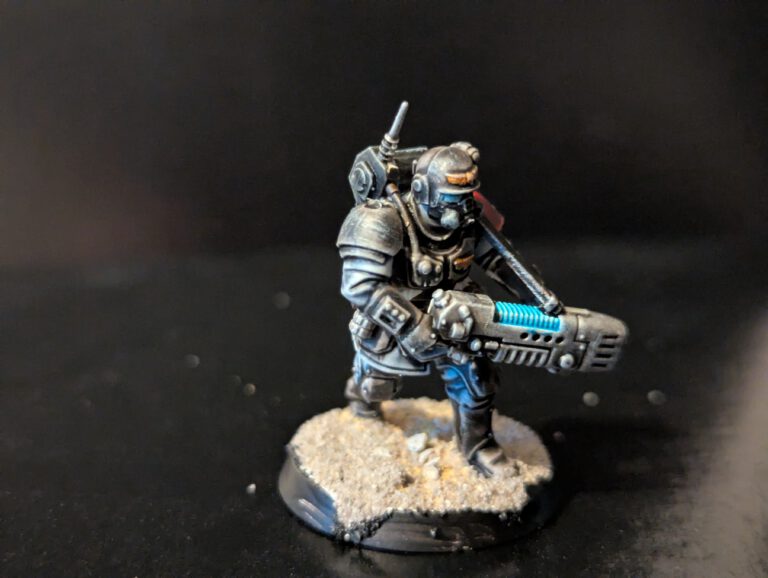 Close-up of a Kasrkin trooper armed with a plasma gun, showcasing a subtle blue plasma glow effect.