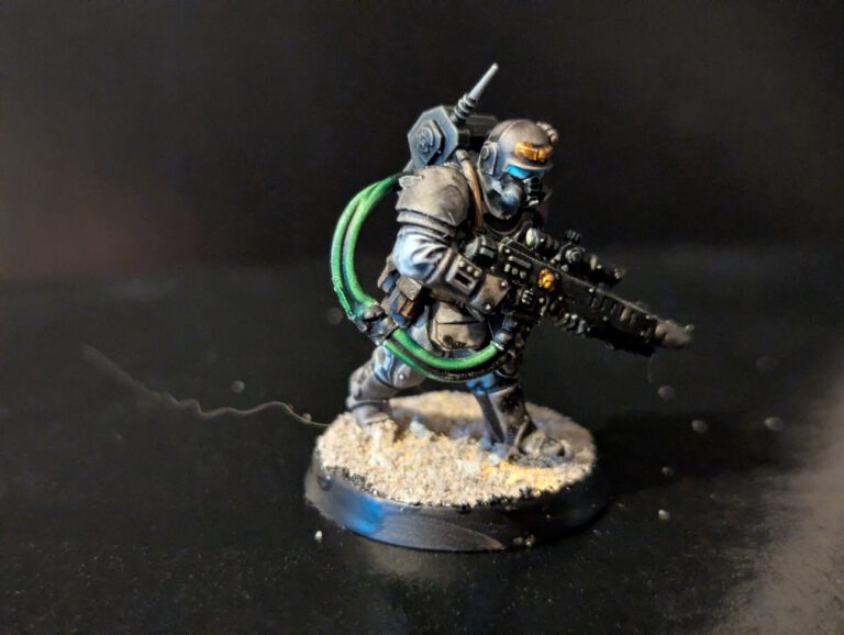 Astra Militarum Kasrkin model carrying a melta gun, featuring heat-staining weathering on the weapon barrel.